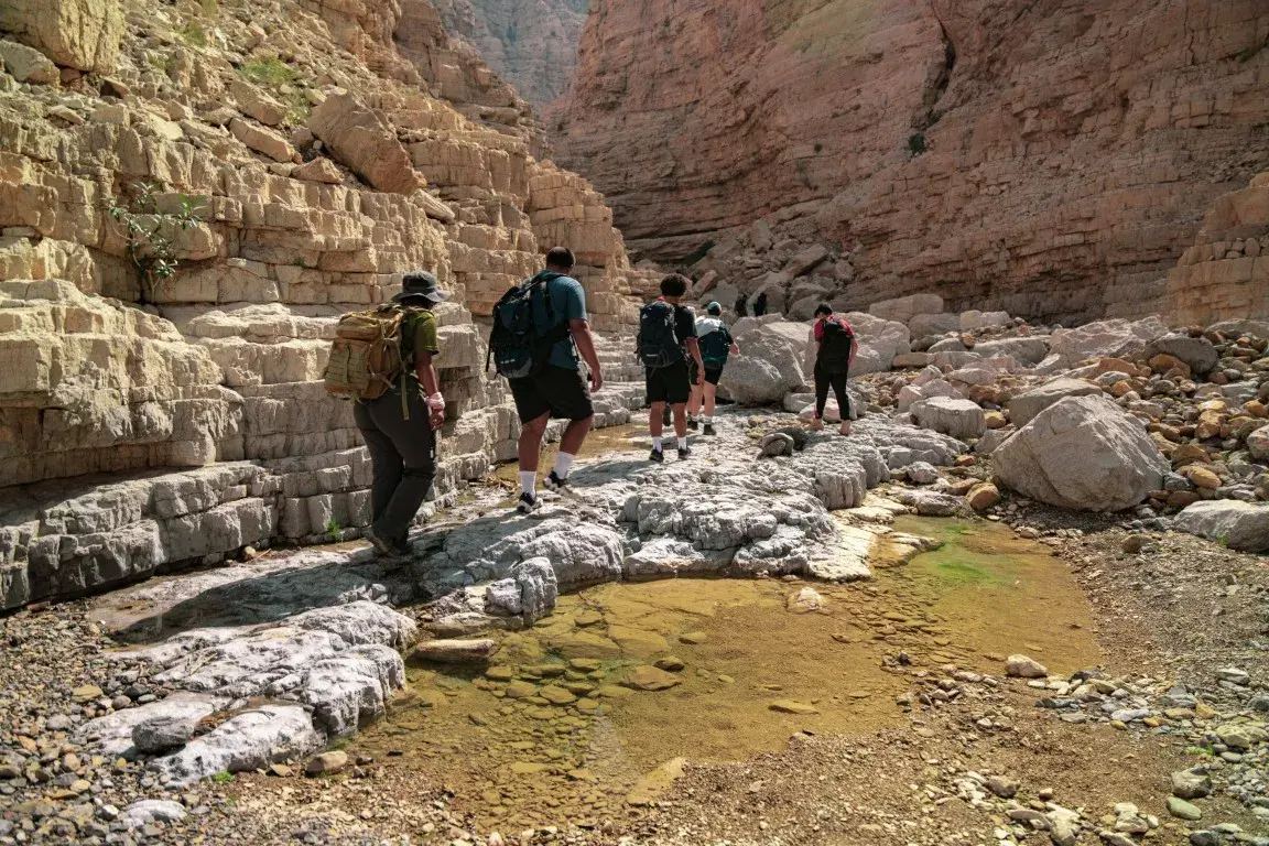 Hikers on the Hidden Oasis route through Wadi Khammed