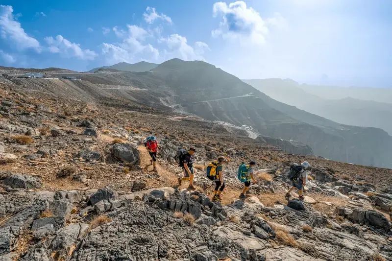 A large guided group hiking together on Jebel Jais